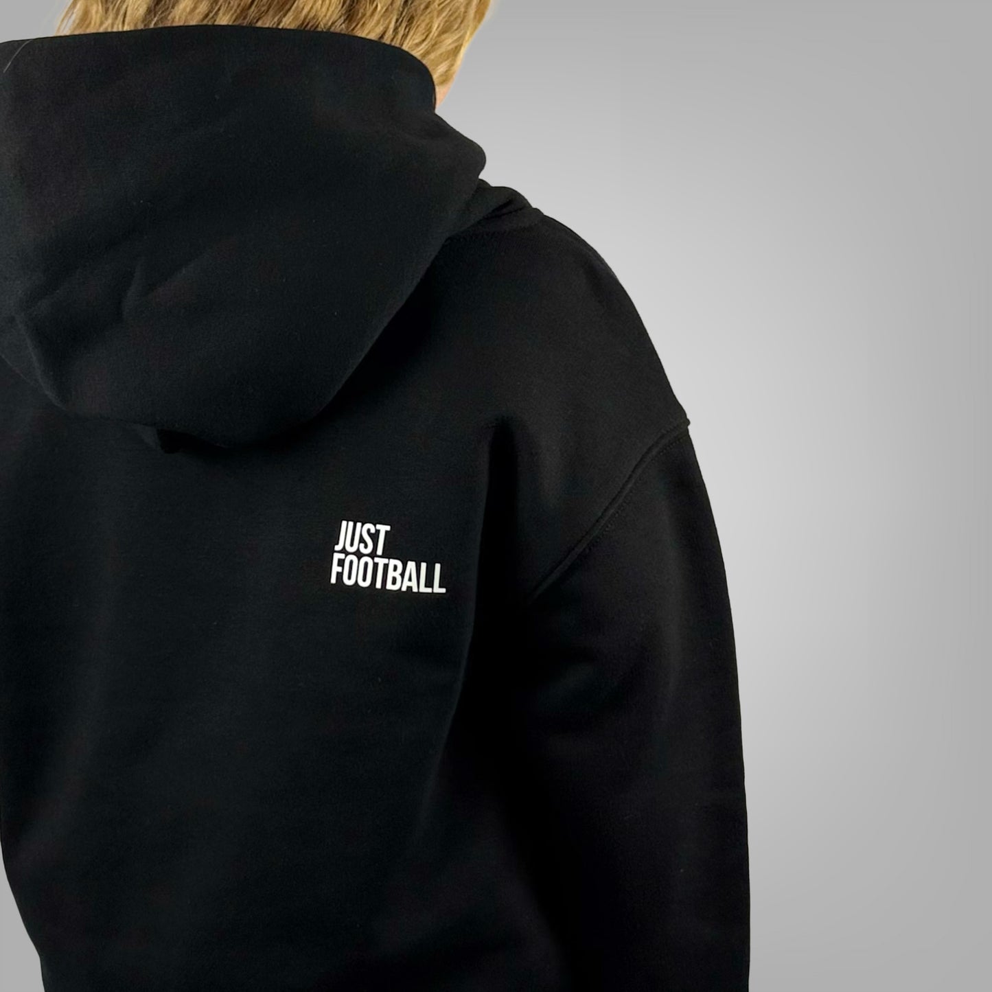 Close up of the Just Football graphic on the ONETWENTI girls relaxed fit hoodie worn by a girl model
