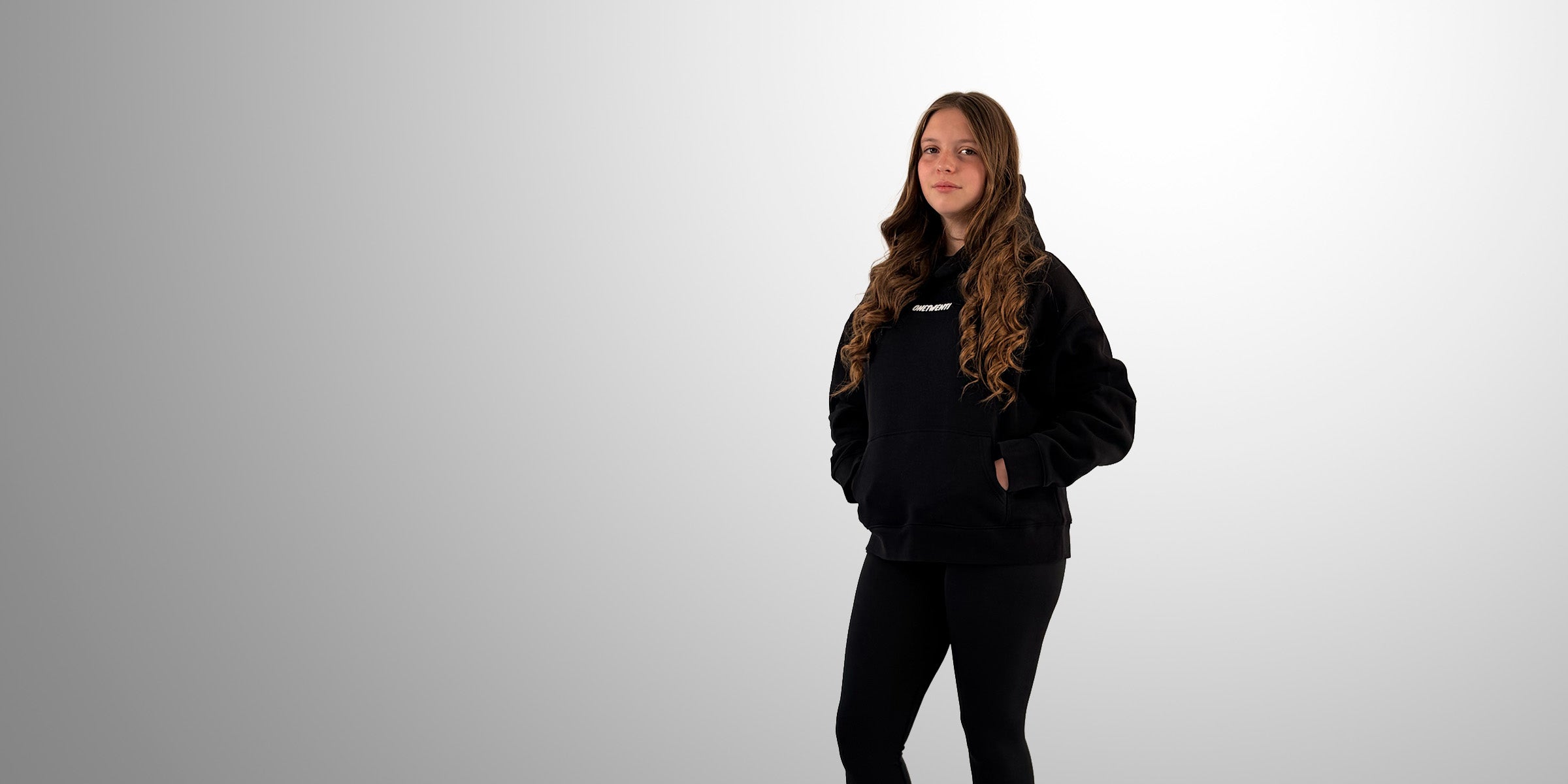 Girl wearing black ONETWENTI hoodie, representing the 120 mindset in women’s football