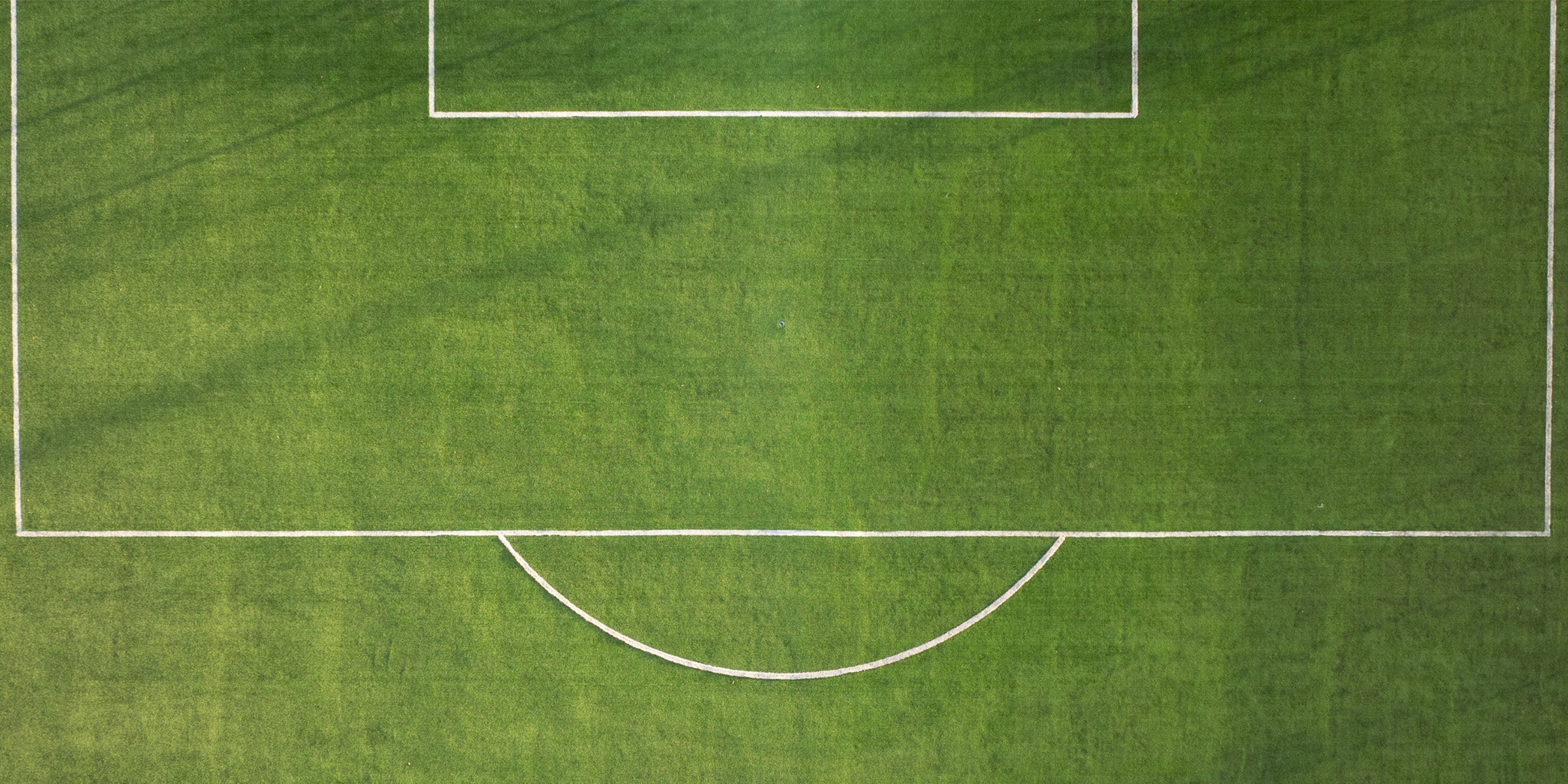 Football pitch viewed from above, representing ONETWENTI 120FC community football events for girls of all abilities