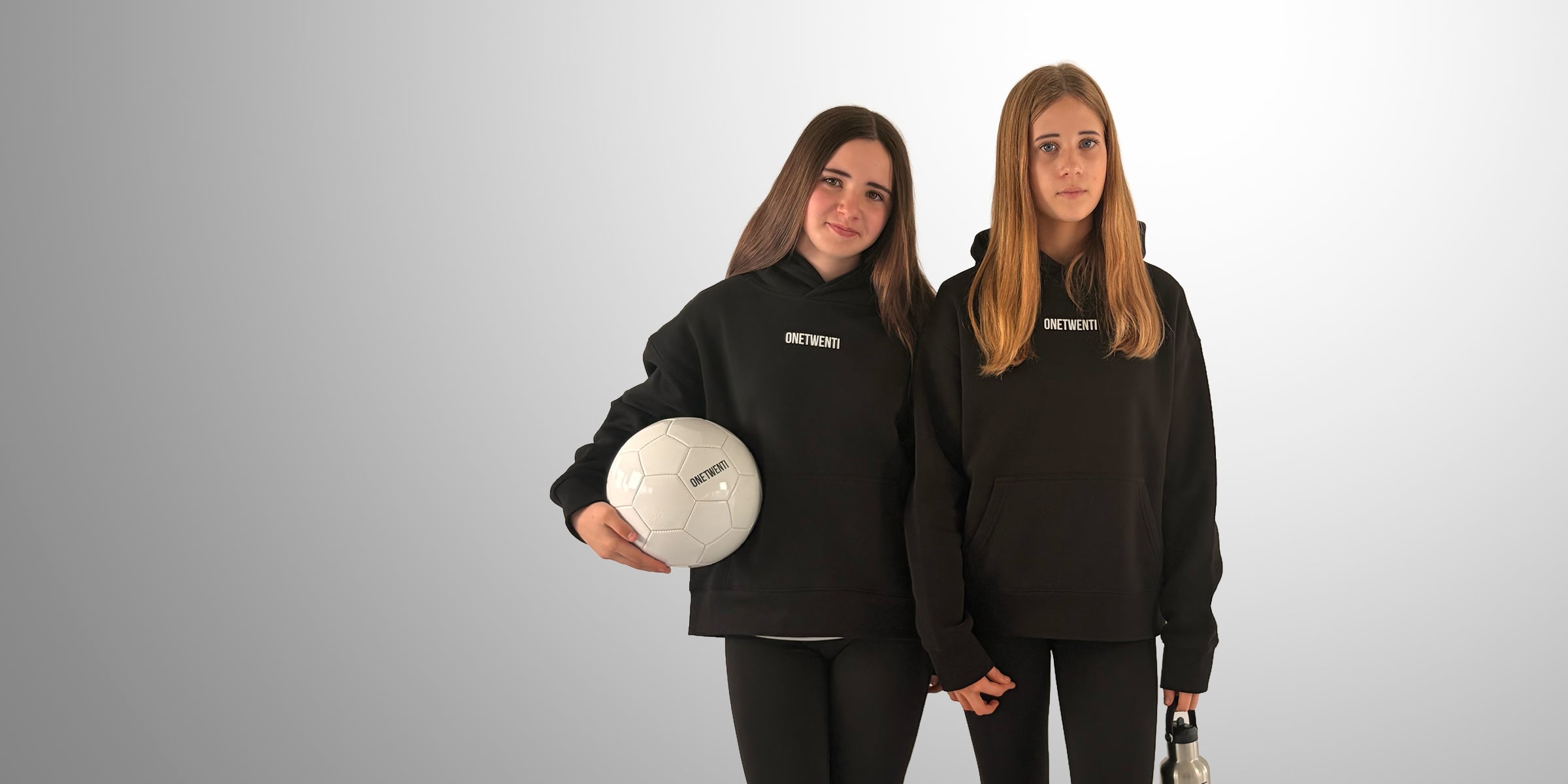 Two girls wearing ONETWENTI hoodies with football, representing joining the 120 Members community