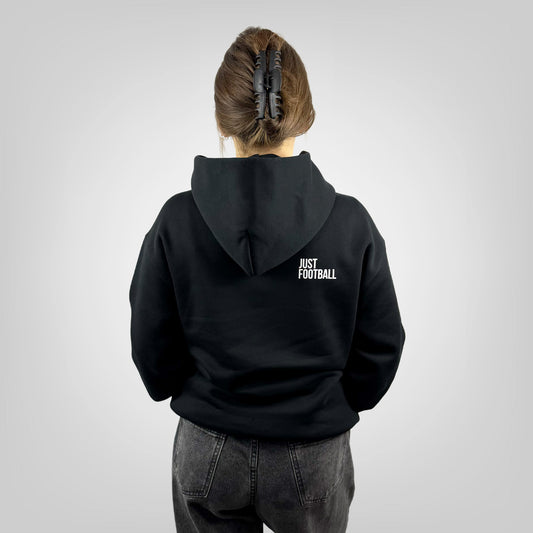 Person wearing a ONETWENTI black hoodie with 'Just Football' text on the back, standing against a plain background