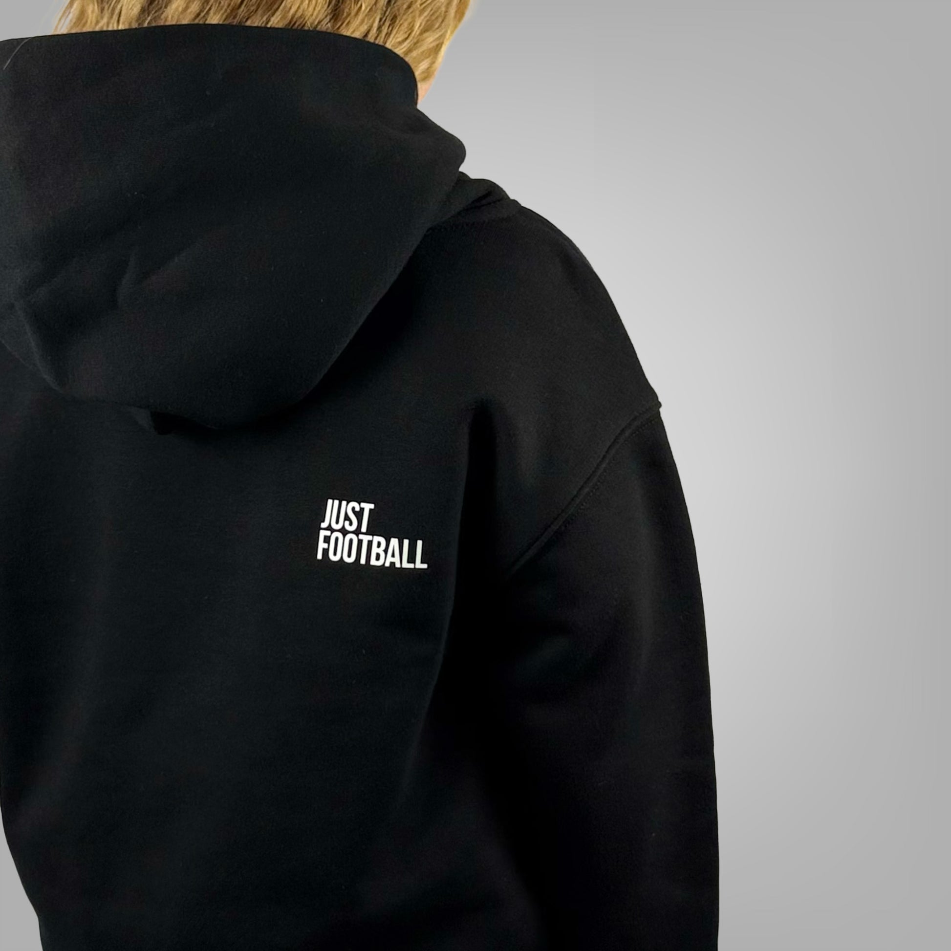 Close up of the Just Football graphic on the ONETWENTI girls relaxed fit hoodie worn by a girl model