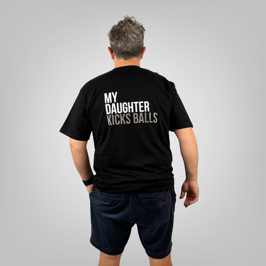MY DAUGHTER KICKS BALLS men's black t-shirt with large back print, rear view on light grey background