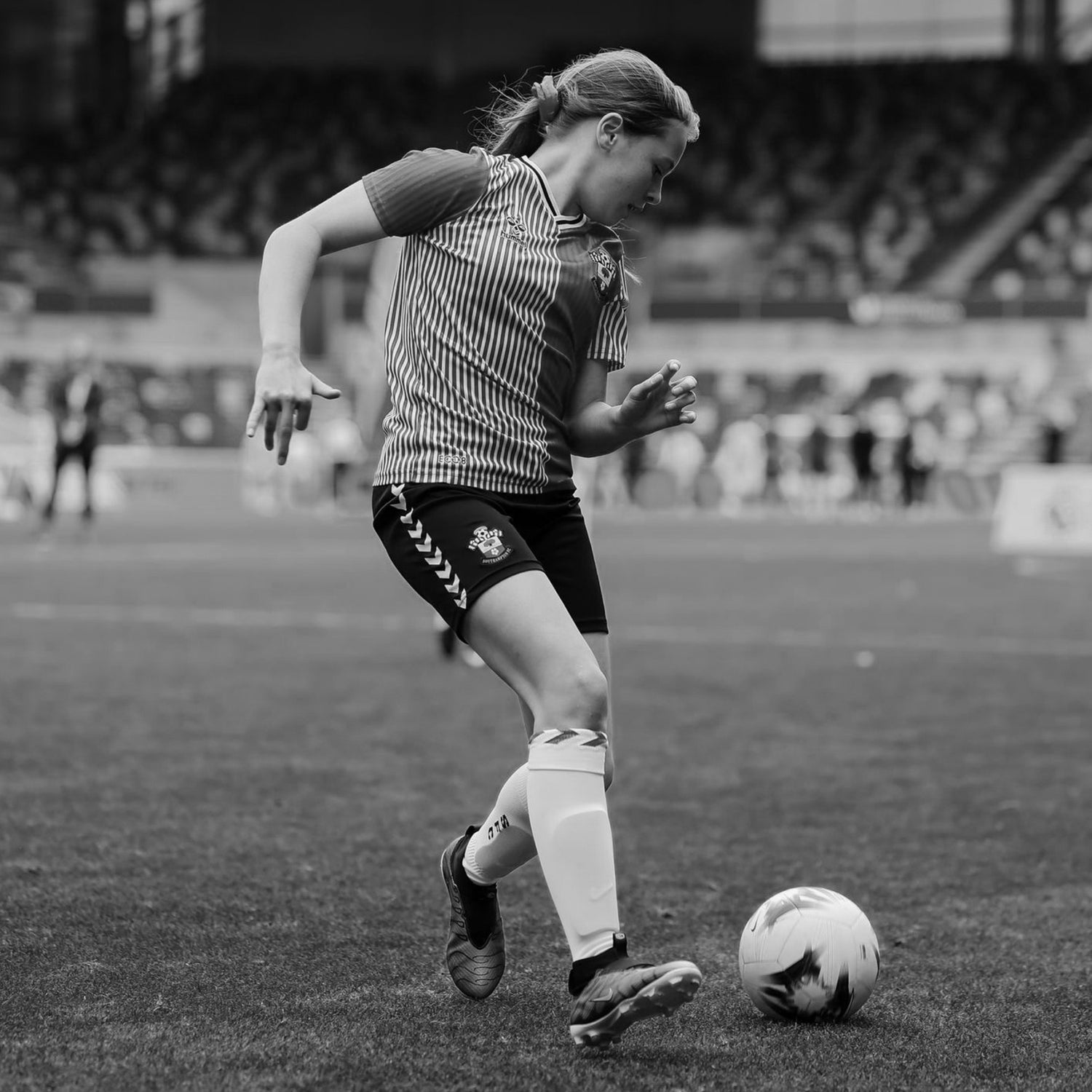 Girl playing football during a match, representing the origin of the 120 mindset and love for the game